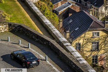 Toyota GT86 Namur – rear three-quarter, black on a cobbled street from above