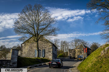 Toyota GT86 Namur – rear view, black on a historic village street