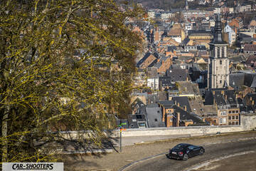 Toyota GT86 Namur – rear three-quarter, black against an aerial city backdrop