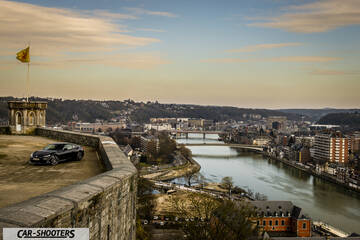 Toyota GT86 Namur – front three-quarter, black against a city and river backdrop