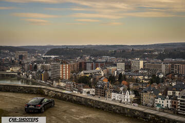 Toyota GT86 Namur – rear three-quarter, black against a cityscape backdrop