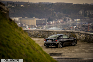 Toyota GT86 Namur – rear three-quarter, black overlooking a town landscape