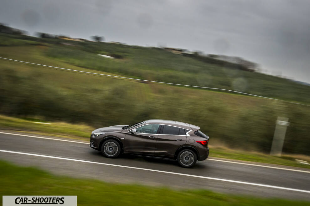 Infiniti Q30 – side profile, brown metallic on a country road