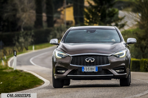 Infiniti Q30 – front three-quarter, brown metallic on a country road