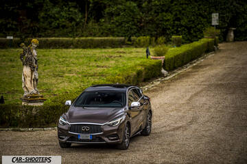Infiniti Q30 – front three-quarter, brown metallic on a gravel driveway