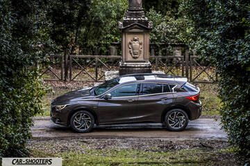 Infiniti Q30 – side profile, brown metallic on a park path