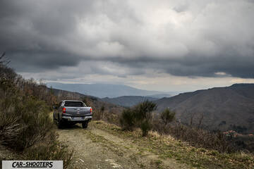 Fiat Professional Fullback – rear three-quarter, grey metallic on a dirt road against a mountain backdrop