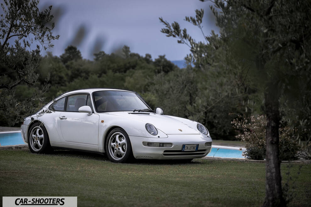 Porsche 993 Carrera 4 – front three-quarter, white parked on a grassy lawn