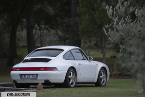 Porsche 993 Carrera 4 – rear three-quarter, white parked on a lawn