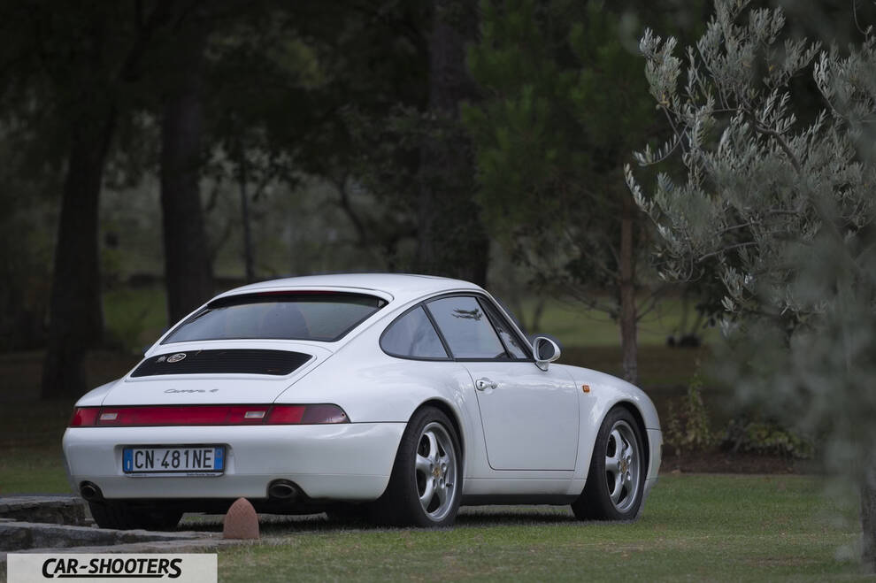 Porsche 993 Carrera 4 – rear three-quarter, white parked on a lawn