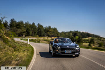 Fiat 124 Spider – front three-quarter, dark grey on a winding country road