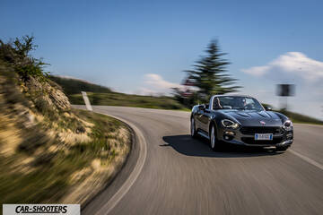 Fiat 124 Spider – front three-quarter, dark grey on a winding country road