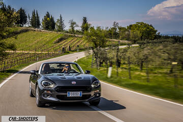 Fiat 124 Spider – front three-quarter, dark grey metallic on a country road