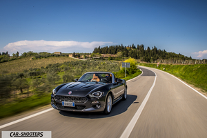 Fiat 124 Spider – front three-quarter, dark grey metallic on a country road