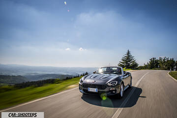 Fiat 124 Spider – front three-quarter, grey metallic on a country road