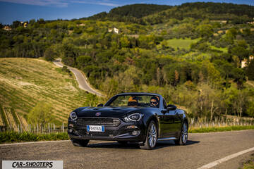 Fiat 124 Spider – front three-quarter, black on a country road