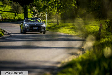 Fiat 124 Spider – front three-quarter, grey metallic on a country road