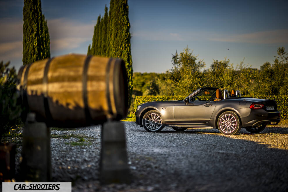 Fiat 124 Spider – side profile, grey metallic on a gravel driveway