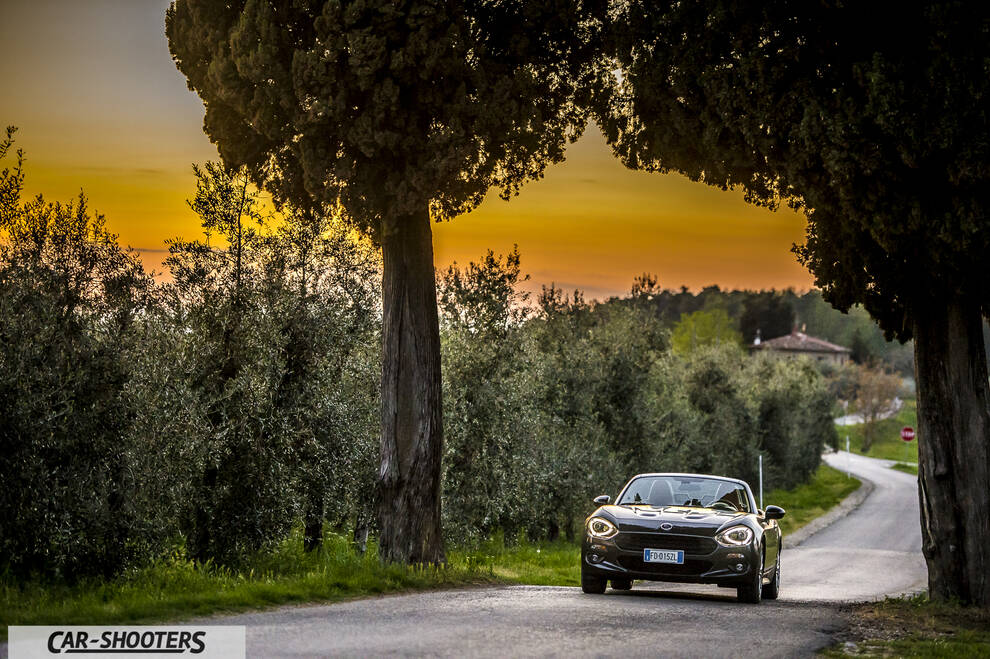 Fiat 124 Spider – front three-quarter, brown metallic on a country road