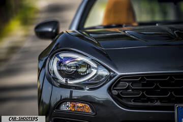 Fiat 124 Spider – front three-quarter, dark grey on a country road