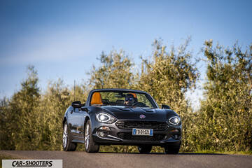 Fiat 124 Spider – front three-quarter, grey metallic on a country road
