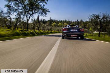 Fiat 124 Spider – rear view, dark grey on a country road