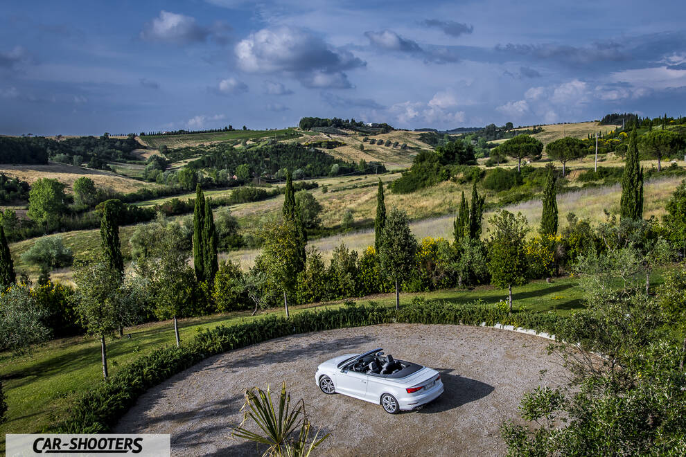 Audi A3 Cabriolet – rear three-quarter, white against a rolling countryside backdrop