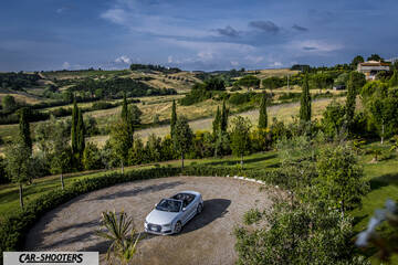 Audi A3 Cabriolet – front three-quarter, white against a rural landscape backdrop