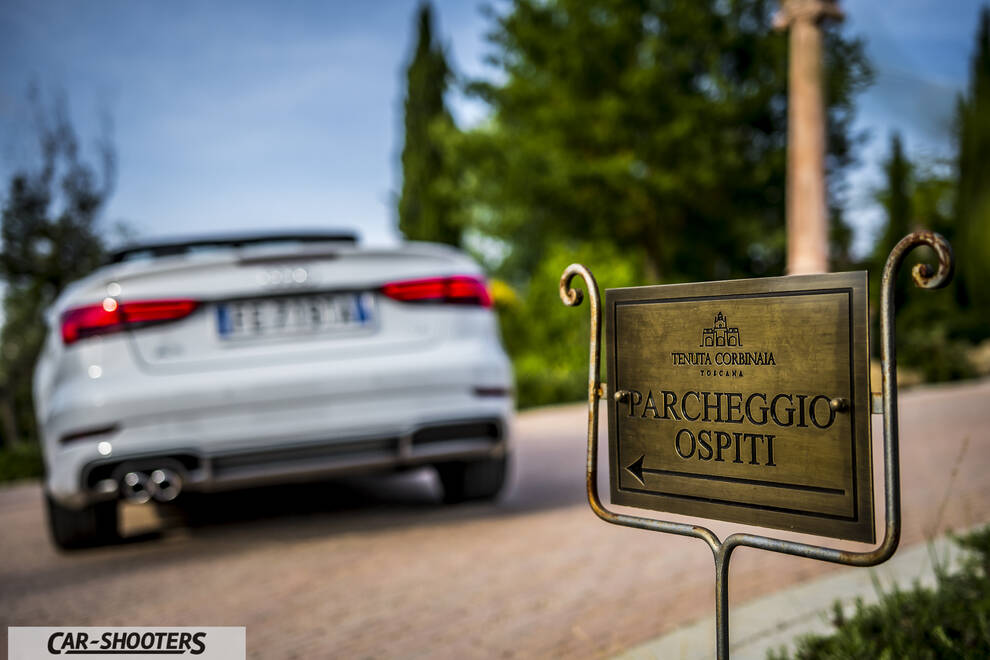 Audi A3 Cabriolet – rear view, white on a driveway with a sign