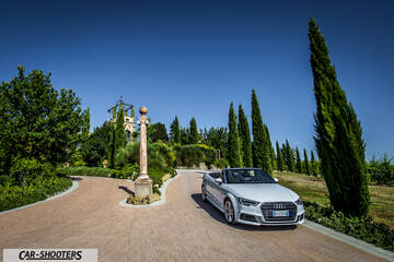 Audi A3 Cabriolet – front three-quarter, silver on a paved driveway with tall trees