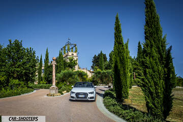 Audi A3 Cabriolet – front three-quarter, white on a driveway with tall trees