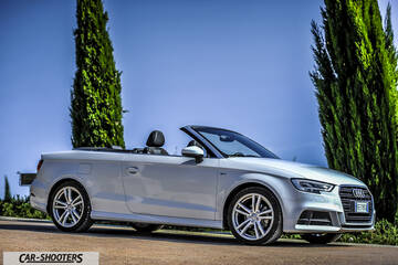 Audi A3 Cabriolet – front three-quarter, silver against tall trees and blue sky