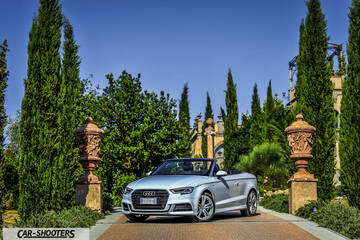 Audi A3 Cabriolet – front three-quarter, silver on a stone driveway between tall trees