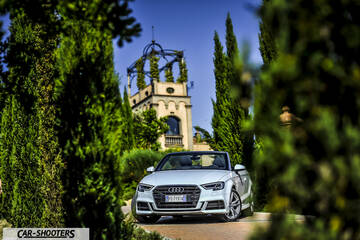 Audi A3 Cabriolet – front three-quarter, white framed by tall green trees