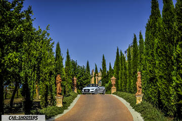 Audi A3 Cabriolet – front three-quarter, silver on a driveway with tall trees