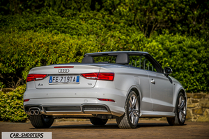 Audi A3 Cabriolet – rear three-quarter, silver against a green hedge backdrop