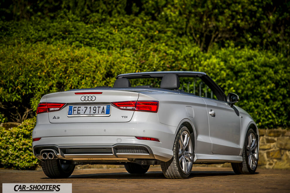 Audi A3 Cabriolet – rear three-quarter, silver against a green hedge backdrop