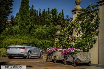 Audi A3 Cabriolet – rear three-quarter, silver parked near an old wall