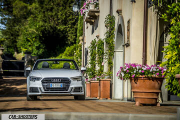 Audi A3 Cabriolet – front three-quarter, silver parked near an old building