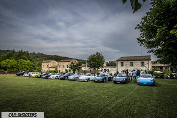 front three-quarter, blue parked on a grassy lawn