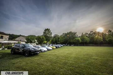 front three-quarter, black parked on a grassy lawn