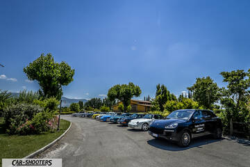 front three-quarter, black parked in a line outside