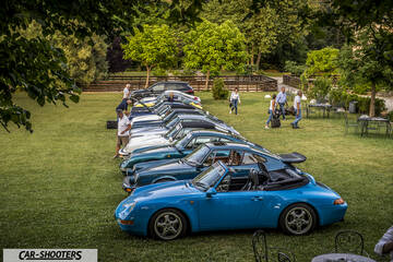 side profile, bright blue parked on a lawn