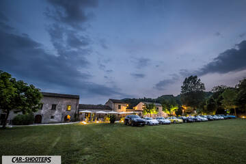 front three-quarter, parked in a grassy courtyard