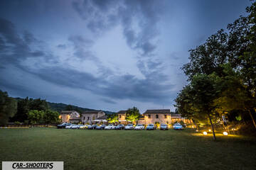 front three-quarter, parked on a lawn at dusk