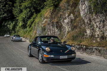 front three-quarter, dark green on a mountain road