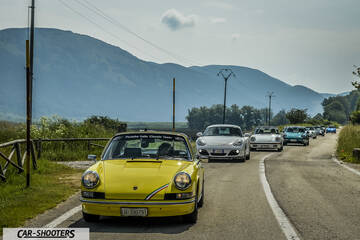 front three-quarter, yellow against a mountain backdrop