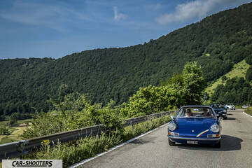 front three-quarter, blue against a mountain backdrop