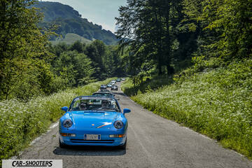 front three-quarter, bright blue on a country road