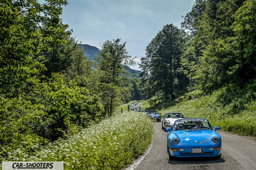 front three-quarter, bright blue on a country road